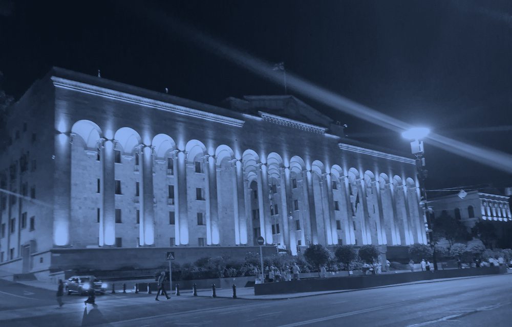 Illuminated riverside building at night